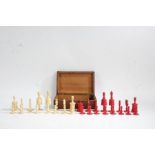 19th Century English bone chess set, with turned pieces, red and natural, the kings 10cm high