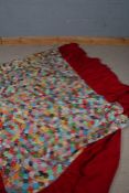 Large 20th century patchwork quilt, consisting of many colourful hexagons set on a red fabric, 260cm