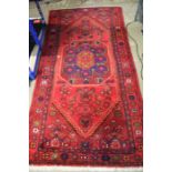 20th century middle eastern rug, with a red and orange ground set with a central medallion and