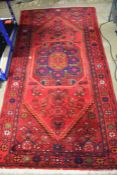 20th century middle eastern rug, with a red and orange ground set with a central medallion and