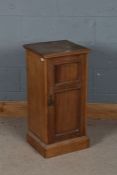 Edwardian pine bedside cupboard, the square top above a single door enclosing a shelf raised on a