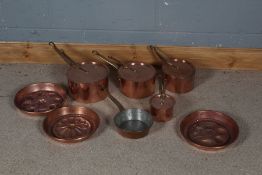 Four copper graduated pots stamped Helvetia together with three copper jelly moulds (8)