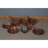 Four copper graduated pots stamped Helvetia together with three copper jelly moulds (8)