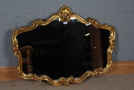 Large 20th century gilt framed over mantle mirror, with a floral and scroll design frame with a