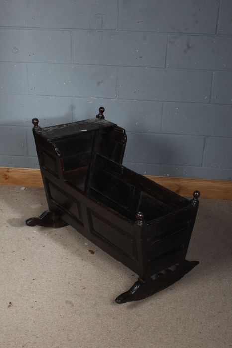 Early 18th century oak crib, possibly Gloucestershire, with partially hinged hood, panelled sides