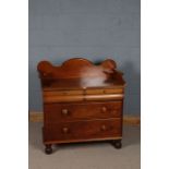 Victorian mahogany dressing chest, with a wavy gallery with two corner shelves above two bombe