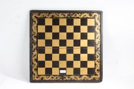 Chinese black lacquered and gilded chess and backgammon board, with a dragon border, 45.5cm square