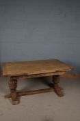 Elizabethan style oak extending dining table, the rectangular top with two pull out drawer leaves