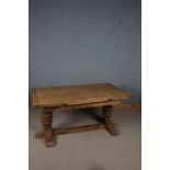 Elizabethan style oak extending dining table, the rectangular top with two pull out drawer leaves