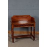 20th century mahogany washstand, with a wooden gallery above two drawers and turned legs joined by a