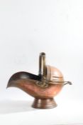 Victorian copper coal scuttle of helmet form, together with wooden carrying handle, 46cm long