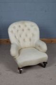 Victorian button back upholstered arm chair, with a cream upholstered stripe fabric raised on a pair