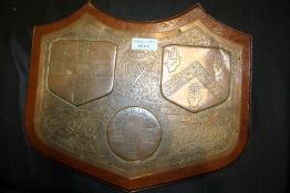 Irish copper and wooden plaque, with three coat of arms to include Dublin together with the Irish