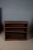 20th century mahogany open bookcase, the rectangular top above two shelves raised on a plinth