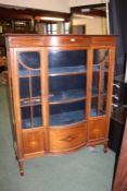 A Edwardian Sheraton Revival mahogany inlaid display cabinet having a bowfronted center section with