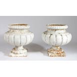Pair of cast iron garden urns, of gadrooned form, painted white, 40cm high, (2)