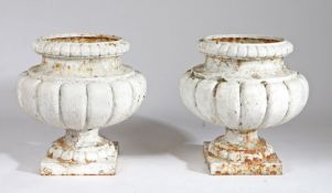 Pair of cast iron garden urns, of gadrooned form, painted white, 40cm high, (2)