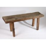 French pig bench, circa 1900, the large rustic top above square section legs, 150cm long, 44cm wide,