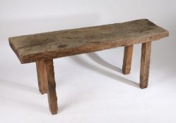 French pig bench, circa 1900, the large rustic top above square section legs, 150cm long, 44cm wide,