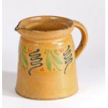 19th Century French slipware jug, with mustard yellow, blue and green decoration, 17cm high