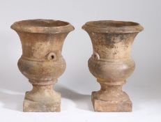 Pair of mid 19th Century terracotta urns, of classical urn form on plinth bases, 57cm high, (2)