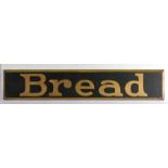 Ebonised advertising panel with gilt lettering "Bread", with bevelled gilt painted border, 90cm