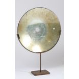 20th Century parabolic mirror, of typical form, raised on a later iron frame, 45cm wide, 67cm high