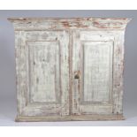 19th Century Swedish dry scraped hanging wall cupboard, the pair of panel doors enclosing two