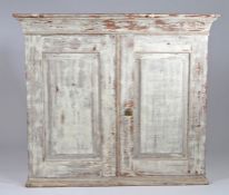 19th Century Swedish dry scraped hanging wall cupboard, the pair of panel doors enclosing two