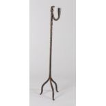 18th Century iron peerman, with candle sconce and rush light holder, on a twisted stem and tripod