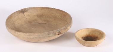 Two turned treen bowls, the first 38cm wide and dated 1831 to the underside, the second 16.5cm wide,