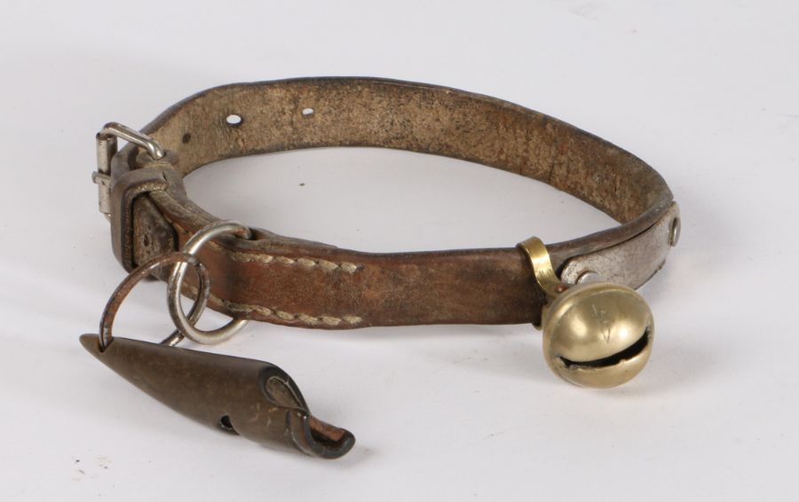 Early 20th Century dog collar and whistle, the leather collar with brass bell and a whistle carved