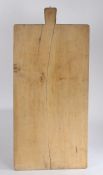 Substantial wooden bread board, with tapering handle to one end, 97.5cm wide, 45.5cm deep