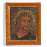 A circa 1900 seed picture, as Jesus Christ, housed within a maple frame, 37.5cm wide, 45cm high