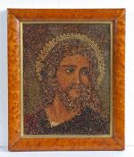 A circa 1900 seed picture, as Jesus Christ, housed within a maple frame, 37.5cm wide, 45cm high