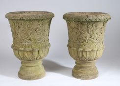 Large pair of stone garden urns, with a lappet edge and carved scroll body above the stepped