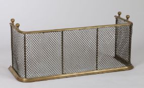 19th Century brass fender, with finial top above a mesh body, 79cm wide, 34cm high