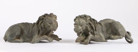 Pair of bronzed metal lions, modelled in laying positions with mouths open, one with tail missing,