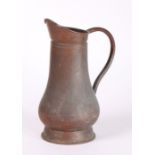 19th Century copper jug, with loop handle and baluster body, on a tapering foot, 35cm high