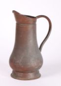 19th Century copper jug, with loop handle and baluster body, on a tapering foot, 35cm high