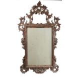 19th Century gilt framed wall mirror, the pierced scroll and foliate frame housing the mirror plate,