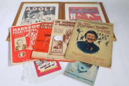 Two framed Second World War music sheets, 'The Washing on the Siegfried Line' and 'Adolf',