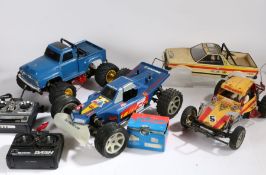 Three remote control cars, the monster truck with Tamiya monster beetle chassis with Ford pickup