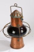 20th century copper ships lamp, with a copper funnel design top above a bulbous red glass body
