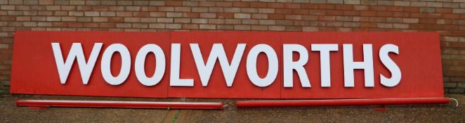 Large original aluminium 'Woolworths' shop sign, with white lettering on a red ground, in three