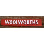 Large original aluminium 'Woolworths' shop sign, with white lettering on a red ground, in three