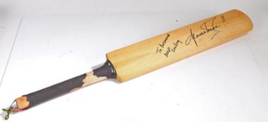 Shane Warne, signed Cricket bat, reading "To Desmond, Keep Smiling, Shane Warne!!", the bat 85m