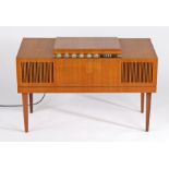 HMV record player, the teak cabinet housing a BSR turntable, raised on square tapering legs, 96cm