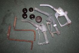 Three each petrol pump handles and nozzles, one stamped 'Cardinal MFG. CO. St Louis', together