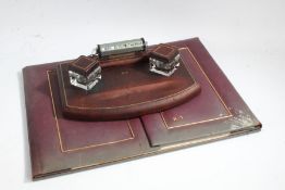 Art Deco brown leather desk stand, with chrome calendar and twin inkwells, initialled R.T., 29.5cm